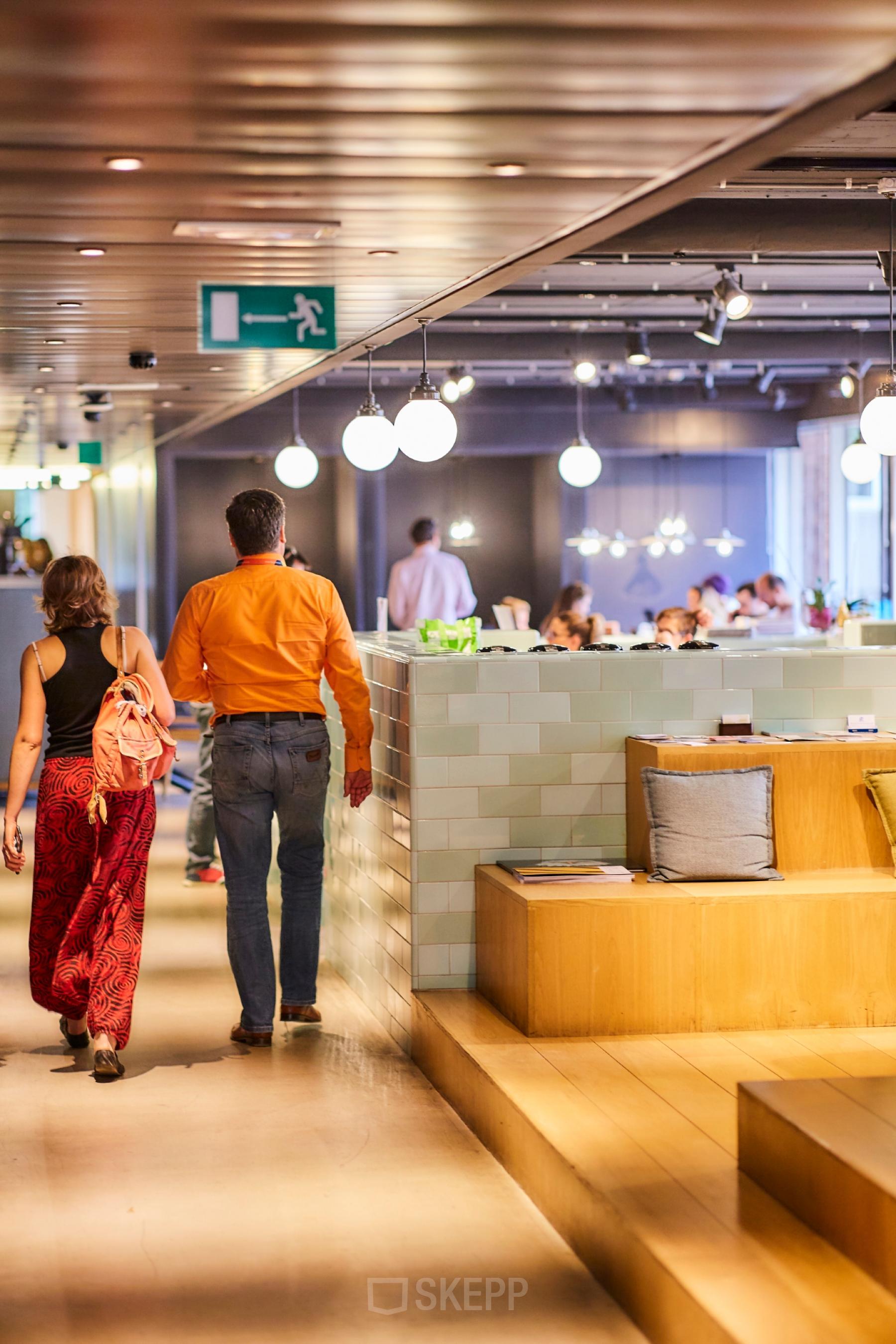 Gezellige kantoorruimte met een moderne uitstraling op Louizalaan/Avenue Louise 523, Brussel Elsene. Mensen overleggen aan tafels. Kantoorruimte te huur met een unieke sfeer.