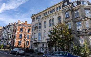 Kantoorruimte te huur op Avenue Palmerston 3, Brussel Europese Wijk, Brussel. Aanzicht van een aantrekkelijk kantoorgebouw in een historische bouwstijl met auto's ervoor geparkeerd.