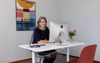 Kantoorruimte te huur aan Avenue Palmerston 3 in Brussel Europese Wijk, met een vrouw bezig aan een bureau met een computer.