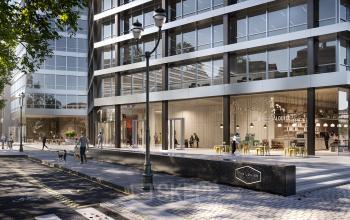 Modern exterieur van kantoor te huur in Brussel Europese Wijk op Avenue Louise/Louizalaan 149, met glazen gevel en mensen bij de ingang. Ideaal om stijlvolle kantoorruimte te huren.